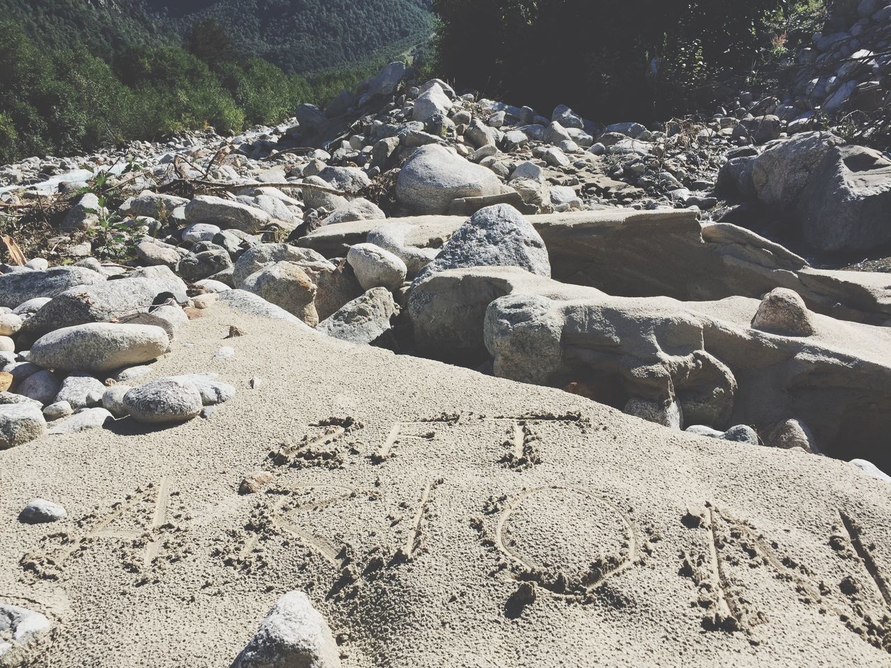 rock - object, water, tranquility, stone - object, tranquil scene, nature, scenics, rock, stone, beauty in nature, beach, day, rock formation, outdoors, sunlight, high angle view, non-urban scene, no people, shore, sand