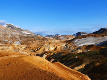 Scenic view of snowcapped mountains against blue sky in iceland