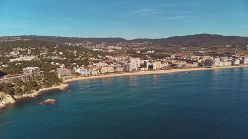 High angle view of townscape by sea against sky