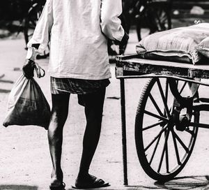 Low section of man with walking cane on street