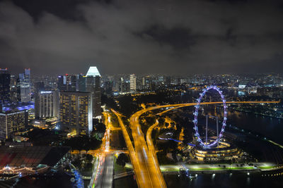 Illuminated cityscape against sky at night