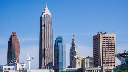 Low angle view of modern buildings against blue sky