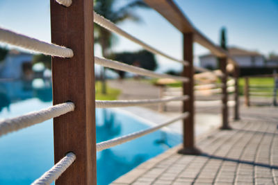 Close-up of rope on railing against sky