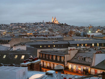 Sacre coeur in winter night from paris rooftop