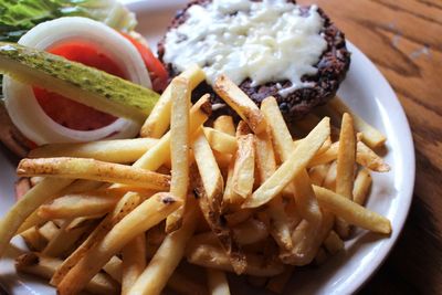 Close-up of burger and fries in plate