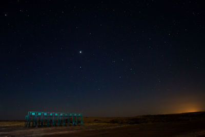 Scenic view of farm against star field at night