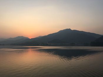 Scenic view of lake at sunset