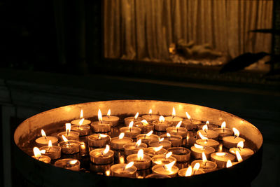 Close-up of tea light candles in temple