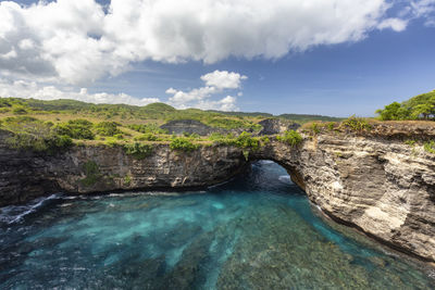 Scenic view of waterfall against sky