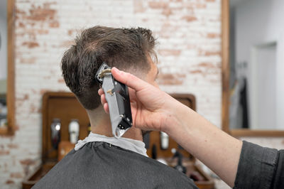 Side view of man photographing with camera