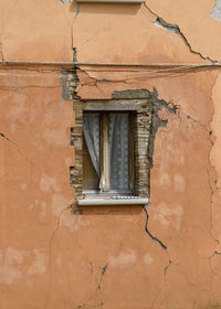 Low angle view of window on old building