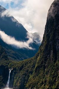 Scenic view of waterfall against sky