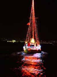 Illuminated lights in water at night