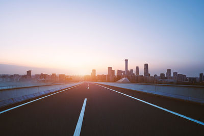 View of city against clear sky during sunset