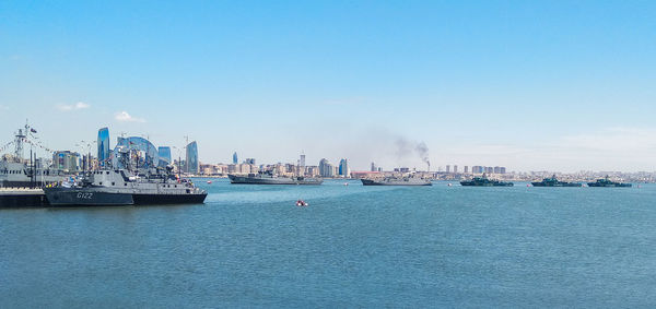 Boats in sea against clear sky