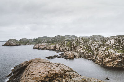 Scenic view of sea and mountains against sky