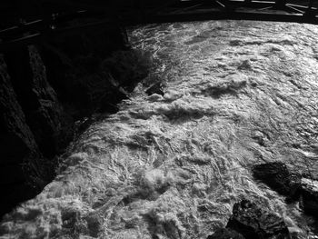 High angle view of water flowing through rocks