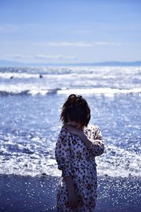 Rear view of girl on beach