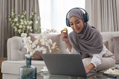 Young woman using laptop at office