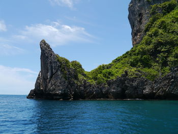 Rock formations in sea against sky