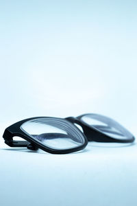 Close-up of eyeglasses on table against white background