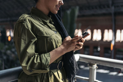 Portrait of modern muslim woman using her smartphone on a train station