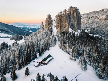 Panoramic view of snow covered mountains against sky