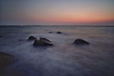 Scenic view of sea against sky at sunset