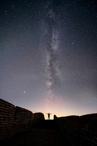 Silhouette man against star field at night