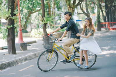 Pre-wedding couple riding a bike together
