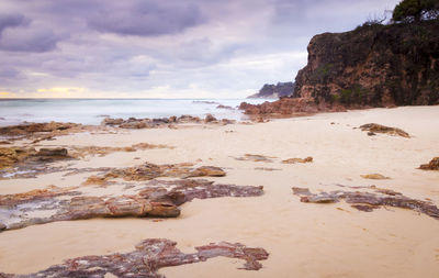 Rocks on beach against sky