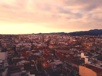 High angle shot of townscape against sky at sunset