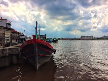 Ship moored in sea against sky