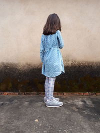 Rear view of woman standing on footpath