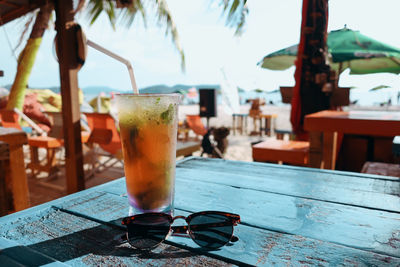 Cocktail and sunglasses on a table in a bar in pantai cenang, langkawi island, malaysia