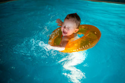 High angle view of boy swimming in pool