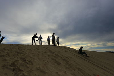 People on beach against sky