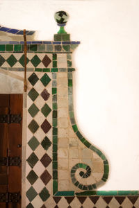 Close-up of tiled floor against wall at home