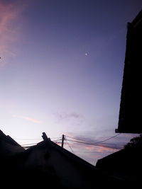 Low angle view of silhouette building against sky