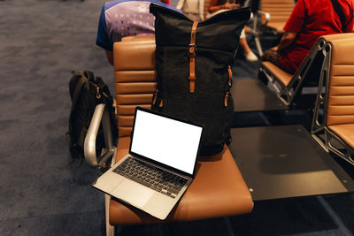 Rear view of woman using laptop on table