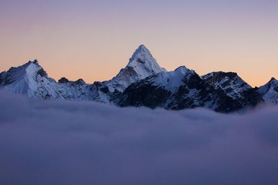 Scenic view of snowcapped mountains against sky during sunset