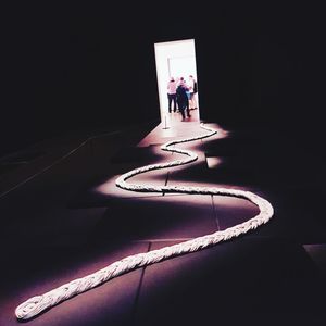 People standing in illuminated dark room