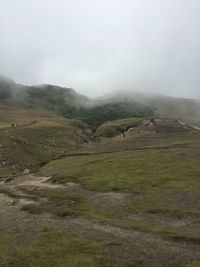 Scenic view of mountains against cloudy sky