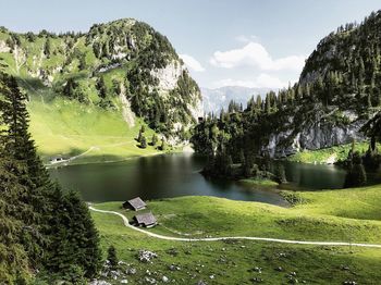 Scenic view of lake by trees against sky