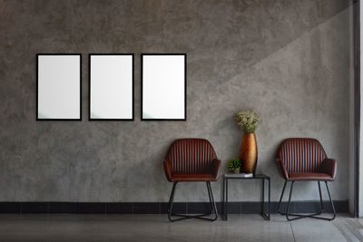 Empty chairs against wall at home