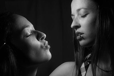 Multiple image of young woman with closed eyes against black background