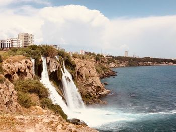 Scenic view of sea and city against sky with waterfall in turkey