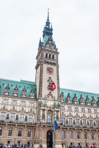 Low angle view of clock tower against sky in city