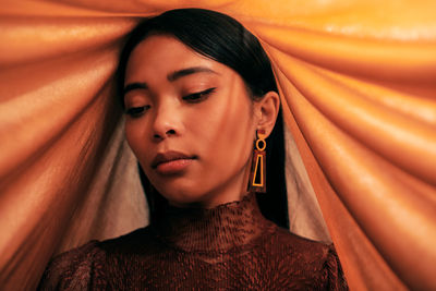 Close-up portrait of beautiful young asian woman with fabric props