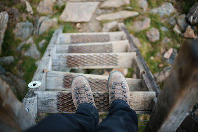 Low section of person on footbridge